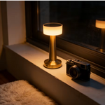 Cordless brushed gold LED table lamp with a modern minimalist design.