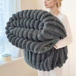 Warm striped sofa blanket for relaxing and watching movies.