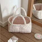 Small floral basket used to store pet toys and accessories.