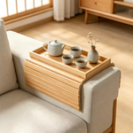 Foldable bamboo sofa armrest organizer for convenient living room storage.