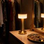 Modern brushed gold accent lamp styled with contemporary bedroom decor.