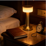Rechargeable gold table lamp featuring convenient touch dimming controls.
