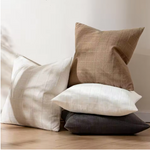 Close-up view of the plaid pattern and texture of a neutral pillow cover